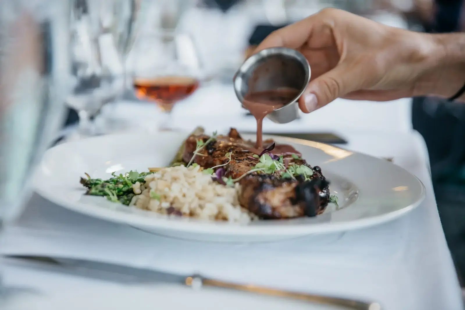 pouring sauce over food