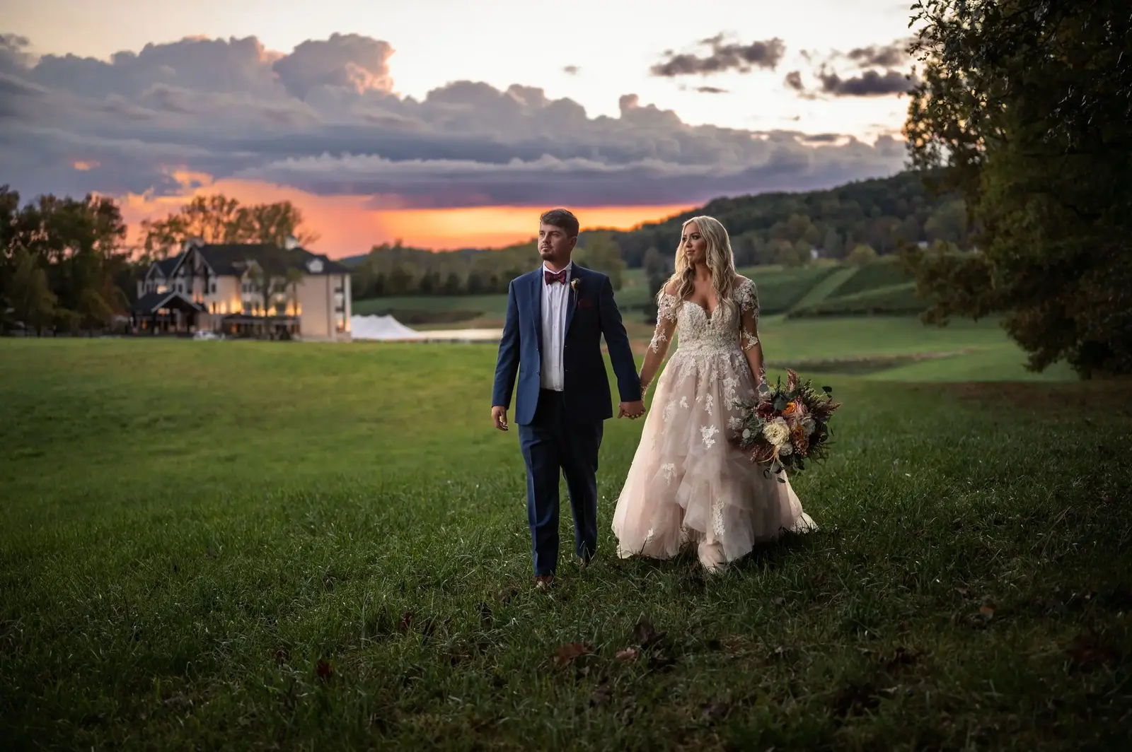 bride and groom walking at sunset