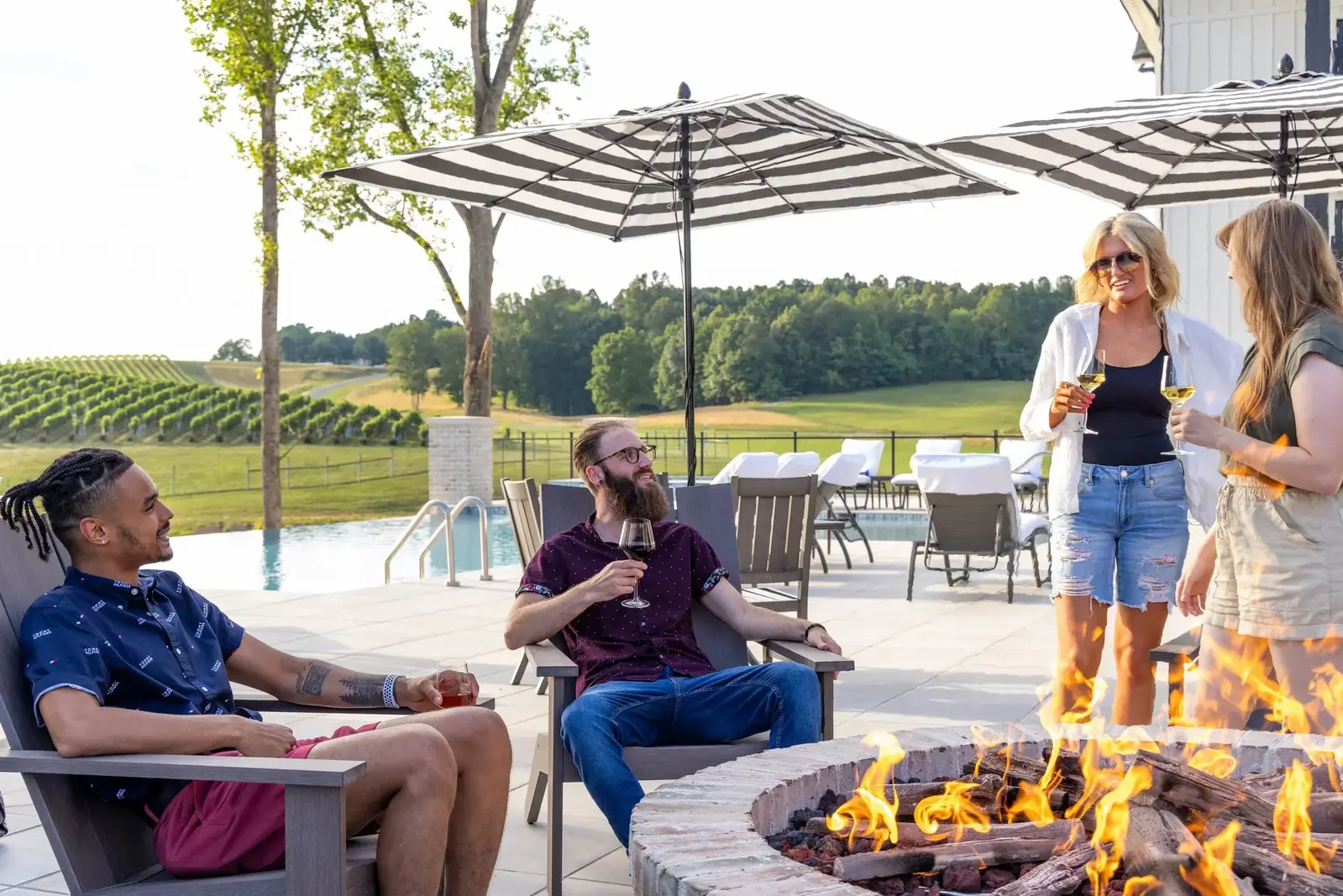 drinking wine around fire pit near pool