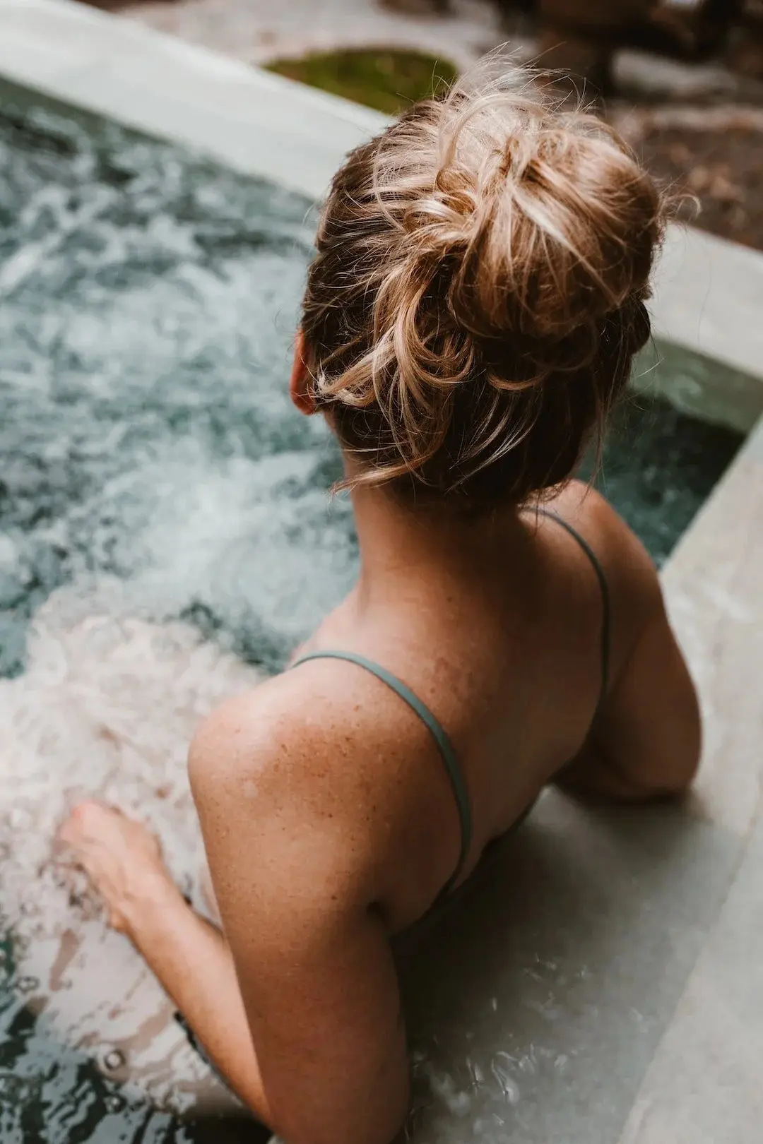 A guest stepping into the cold plunge pool