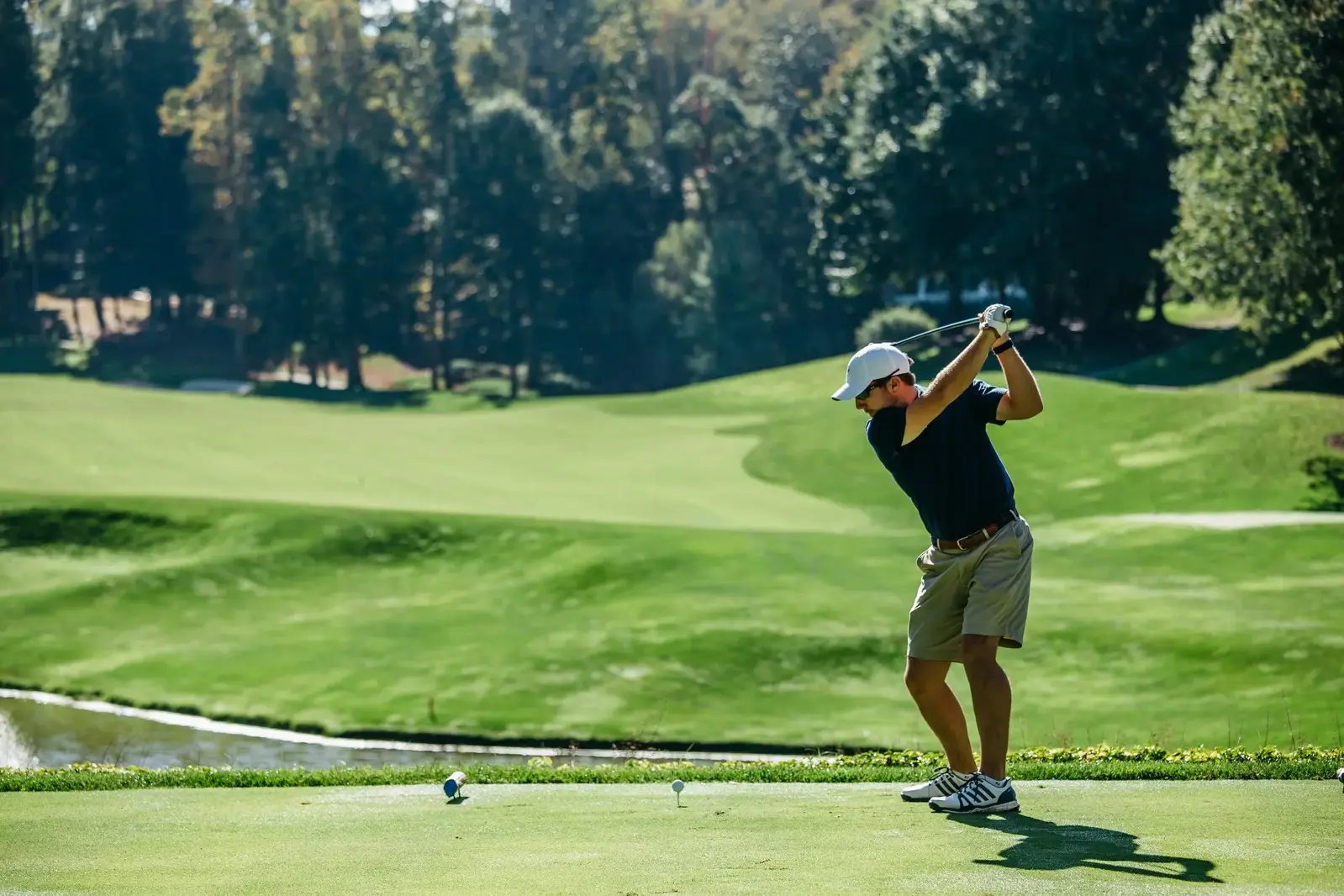 man swinging golf club