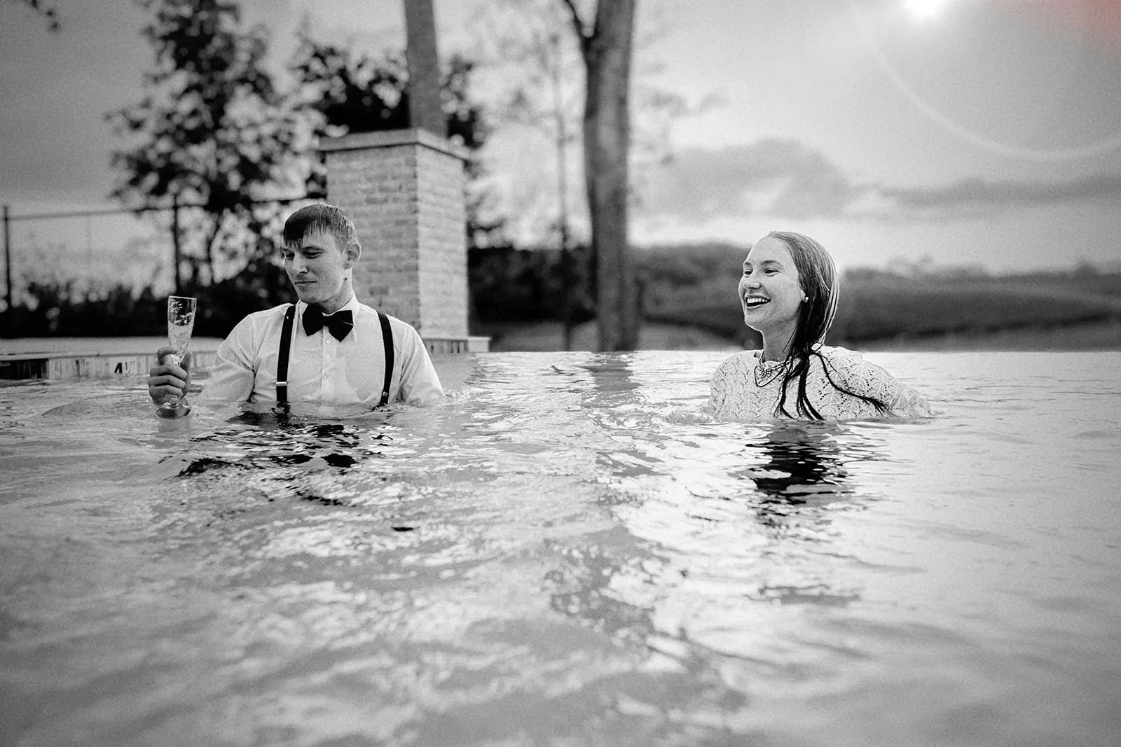 couple wearing clothes in pool